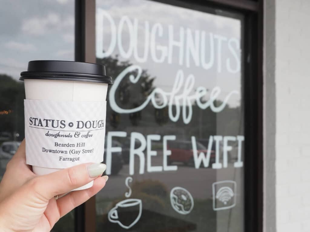 hot coffee outside the window of status dough that advertises free wifi
