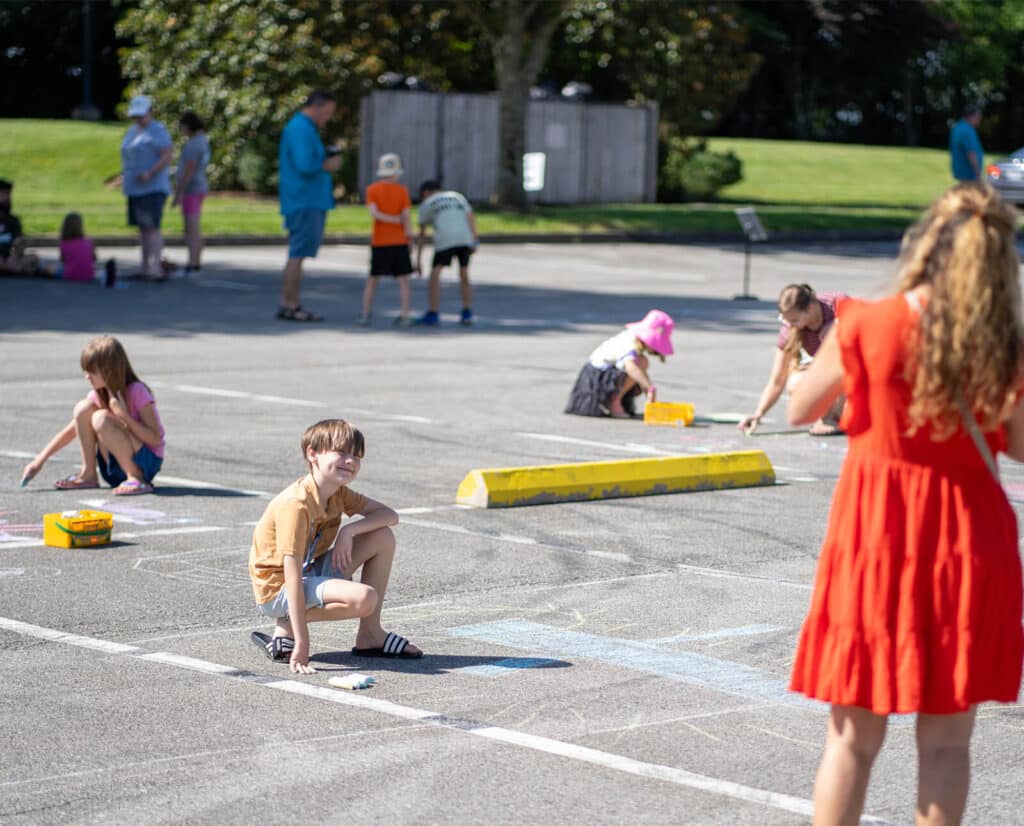 A group of children drawing with chalk at a Farragut Parks and Recreation event.