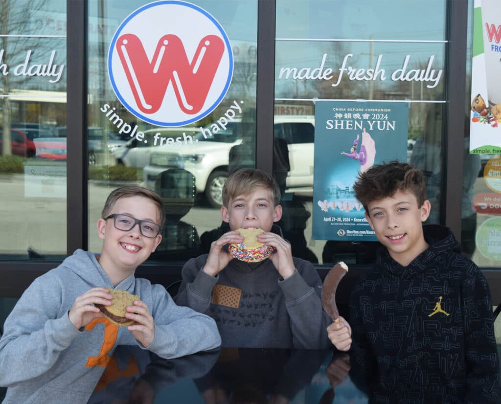 Three kids holding their sweet treat outside of Whit's Frozen Custard.